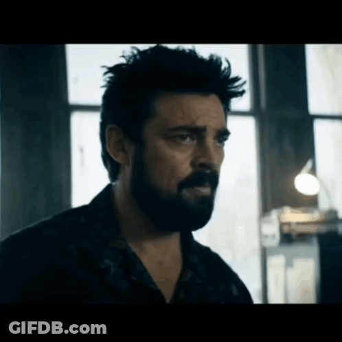 Bearded Man Looking In Dark Room GIF