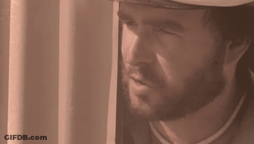 Bearded Man Looking Out Window With Mouth Open GIF