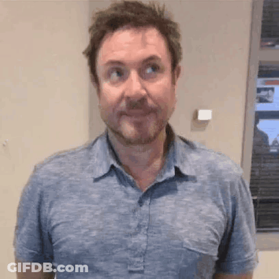 Bearded Man Making Funny Face In Blue Shirt GIF