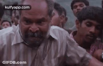 Bearded Man Making Funny Face In Crowd GIF