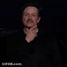 Bearded Man Making Funny Face In Dark Room GIF