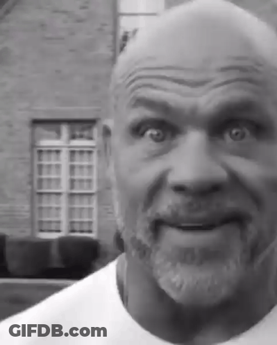 Bearded Man Making Funny Face In Front Of Brick Building GIF