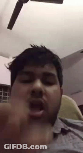 Bearded Man Making Funny Face In Front Of Ceiling Fan GIF