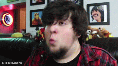 Bearded Man Making Funny Face In Front Of Coca Cola Sign GIF