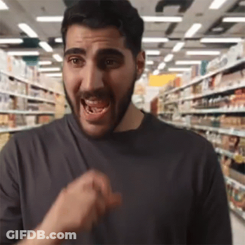 Bearded Man Making Funny Face In Grocery Aisle GIF