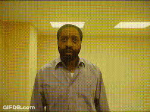 Bearded Man Making Funny Face In Hallway GIF