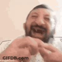 Bearded Man Making Funny Face On Bed GIF