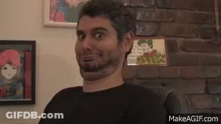 Bearded Man Making Funny Face On Couch GIF