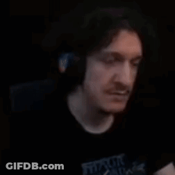 Bearded Man Making Hand Gesture In Dark Room GIF