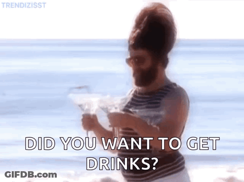 Bearded Man On Beach Holding Martini Asking If He Wants Drinks GIF