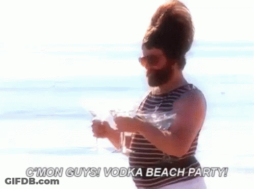 Bearded Man On Beach Holding Vodka And Martini GIF