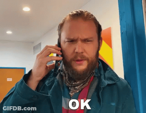 Bearded Man On Cell Phone Saying Ok GIF