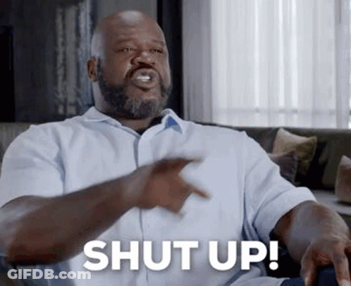 Bearded Man On Couch Pointing Saying Shut Up GIF