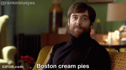 Bearded Man On Couch Saying Boston Cream Pies GIF