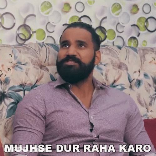 Bearded Man On Couch Saying Mujhse Dur Raha Karo GIF