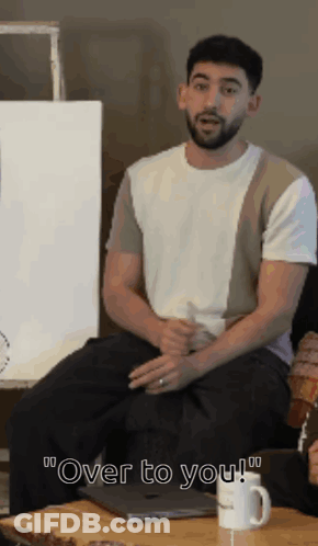Bearded Man On Couch Saying Over To You GIF
