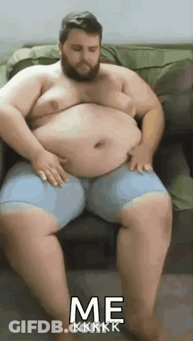 Bearded Man On Couch With Hands On Belly GIF