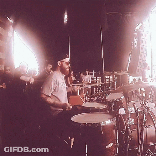 Bearded Man Playing Drums For Crowd GIF