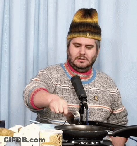 Bearded Man Pouring Oil Into Frying Pan GIF