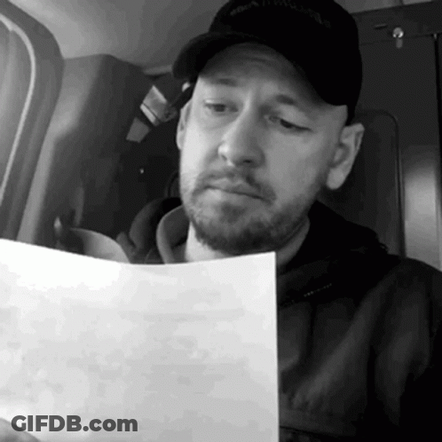 Bearded Man Reading Paper GIF