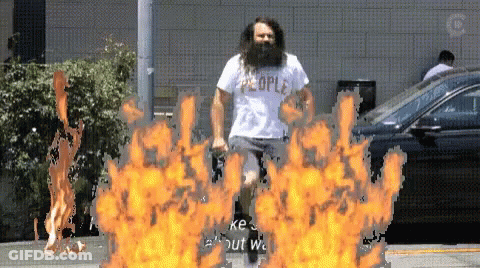 Bearded Man Running Through Fire In People Shirt GIF