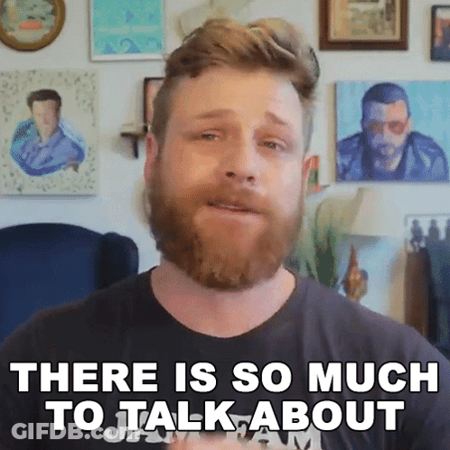 Bearded Man Saying There Is So Much To Talk About In Front Of Paintings GIF