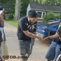 Bearded Man Shaking Hands With Another Man In Front Of Car GIF