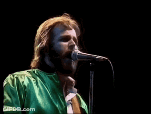 Bearded Man Singing Into Microphone In Green Shirt GIF