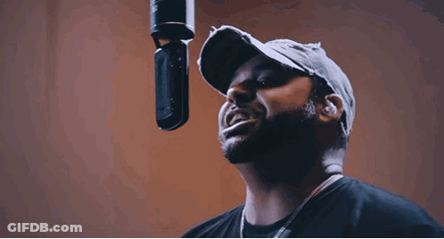 Bearded Man Singing Into Microphone In Studio GIF