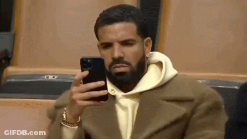 Bearded Man Sitting And Looking At Phone GIF