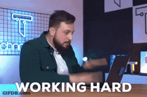 Bearded Man Sitting At Desk With Laptop Working Hard GIF