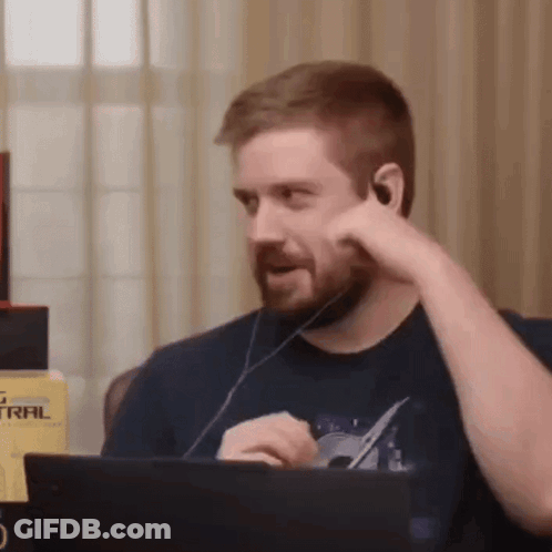Bearded Man Sitting At Laptop With Headphones GIF