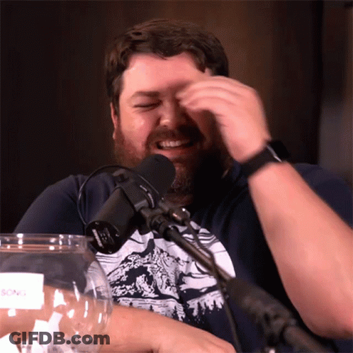 Bearded Man Sitting At Microphone With Glass GIF