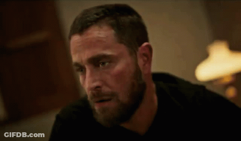 Bearded Man Sitting At Table With Lamp GIF
