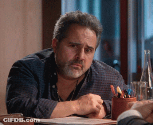 Bearded Man Sitting At Table With Water Bottle GIF