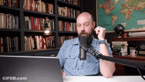 Bearded Man Sitting Before Microphone GIF