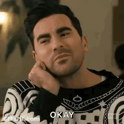 Bearded Man Sitting Hand On Chin Saying Okay GIF