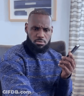Bearded Man Sitting In Chair Holding Phone GIF