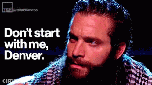 Bearded Man Sitting In Front Of Don't Start With Me Denver Sign GIF