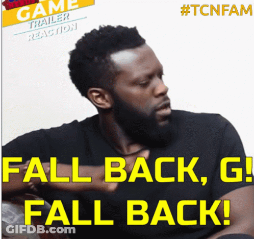 Bearded Man Sitting In Front Of Fall Back G Fall Back Sign GIF