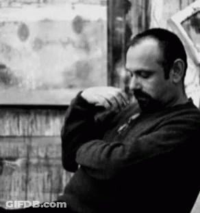 Bearded Man Sitting In Front Of Window GIF