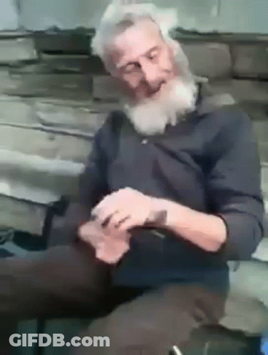 Bearded Man Sitting On Bench Playing Cards Eyes Closed GIF