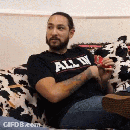 Bearded Man Sitting On Couch In T-Shirt GIF