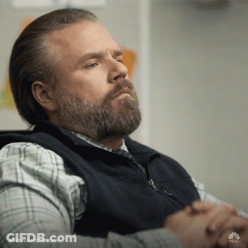 Bearded Man Sitting With Folded Hands GIF