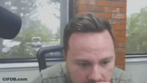 Bearded Man Sitting With Mouth Open By Window GIF
