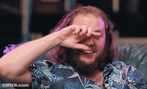 Bearded Man Smiling And Covering Eyes GIF