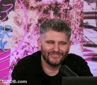Bearded Man Smiling At Microphone In Front Of Computer GIF