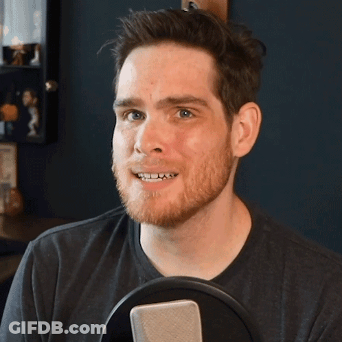 Bearded Man Smiling Holding Microphone GIF