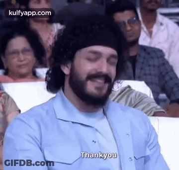 Bearded Man Smiling In Crowd GIF