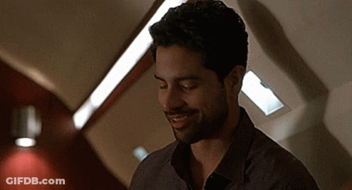 Bearded Man Smiling In Dark Room GIF